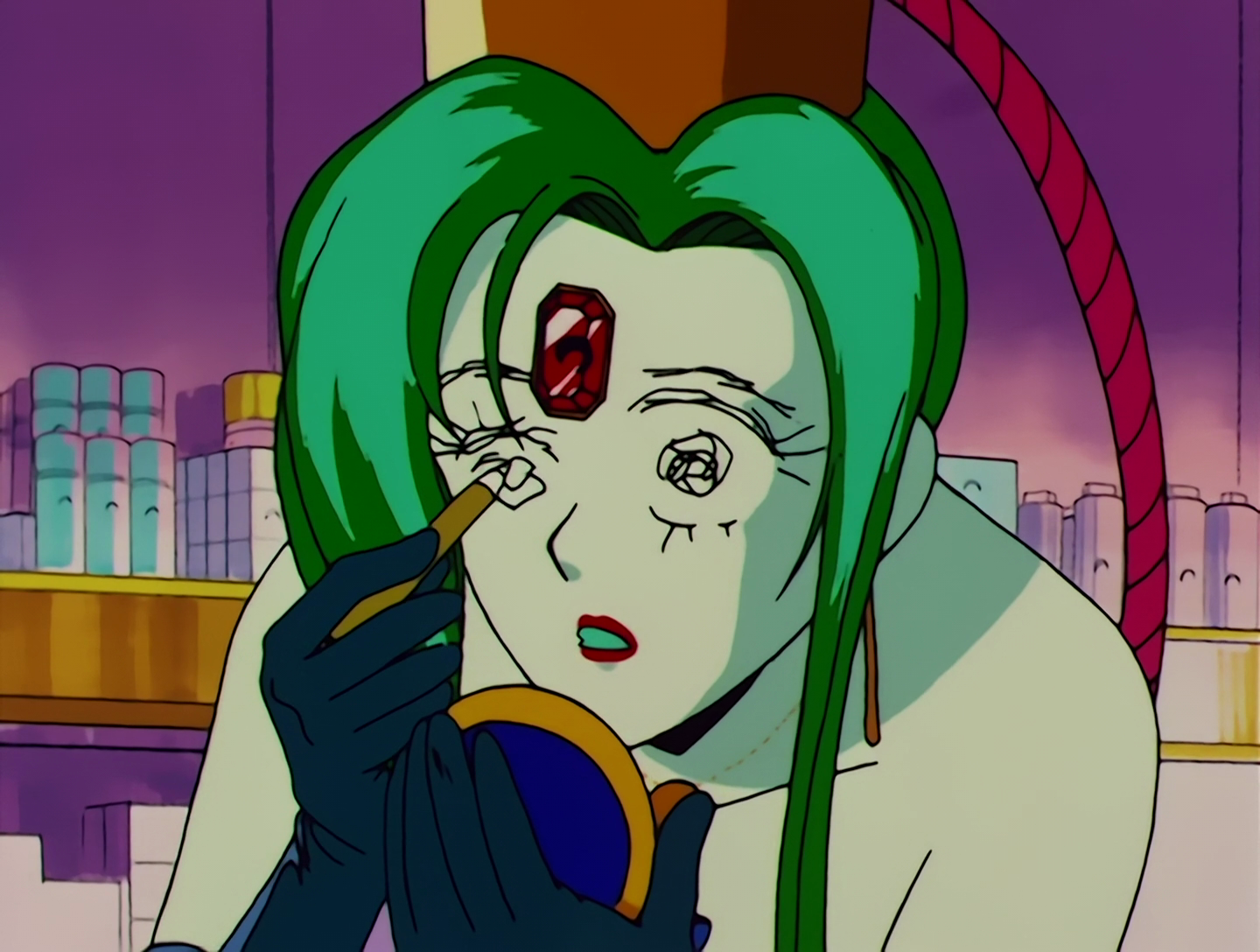 A closeup of Atsugessho. So yeah, it turns out her eyes were just drawn on with makeup, and now she’s hastily trying to draw them while holding up a hand mirror. I’m not sure how the mirror’s supposed to help because her eyes were erased, but maybe that’s why she’s drawn them back on so badly.